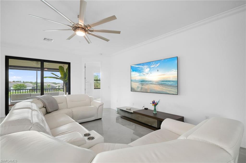 11879 Arboretum Run Drive, Unit 201 Fort Myers, FL 33913 - Photo 8 of 37 Living room featuring ornamental molding and ceiling fan