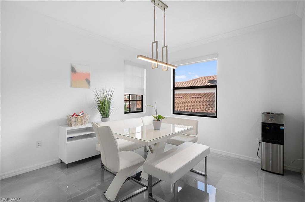 11879 Arboretum Run Drive, Unit 201 Fort Myers, FL 33913 - Photo 9 of 37 Dining area featuring crown molding and baseboards