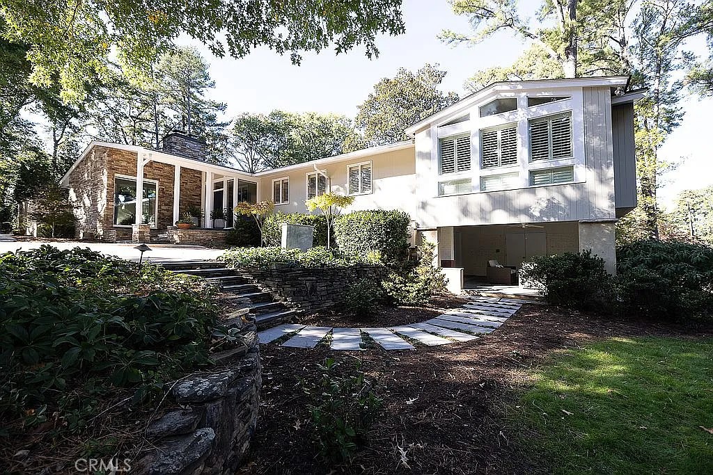 a front view of a house with yard and green space
