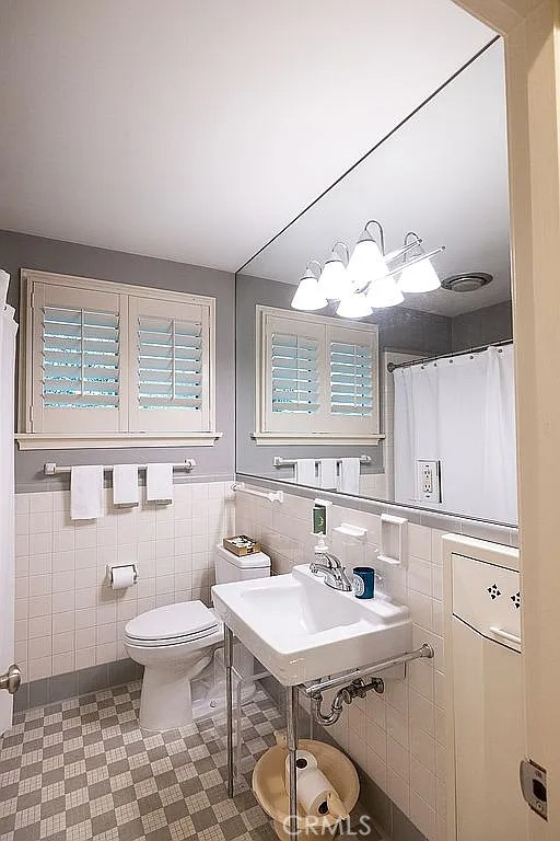 2751 Toxey Drive Raleigh, NC 27609 - Photo 20 of 41 a bathroom with a sink a toilet and a mirror