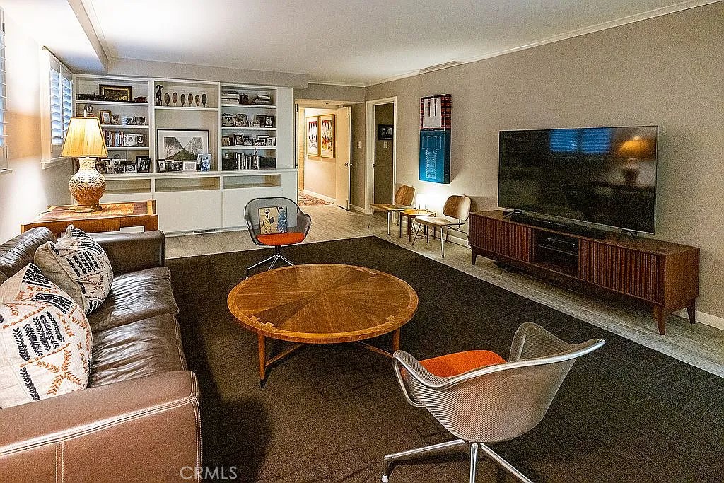 2751 Toxey Drive Raleigh, NC 27609 - Photo 30 of 41 a living room with furniture a flat screen tv and floor to ceiling windows