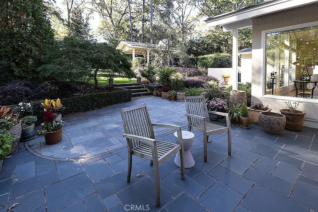 2751 Toxey Drive Raleigh, NC 27609 - Photo 38 of 41 a view of a patio with couches table and chairs potted plants and a large tree