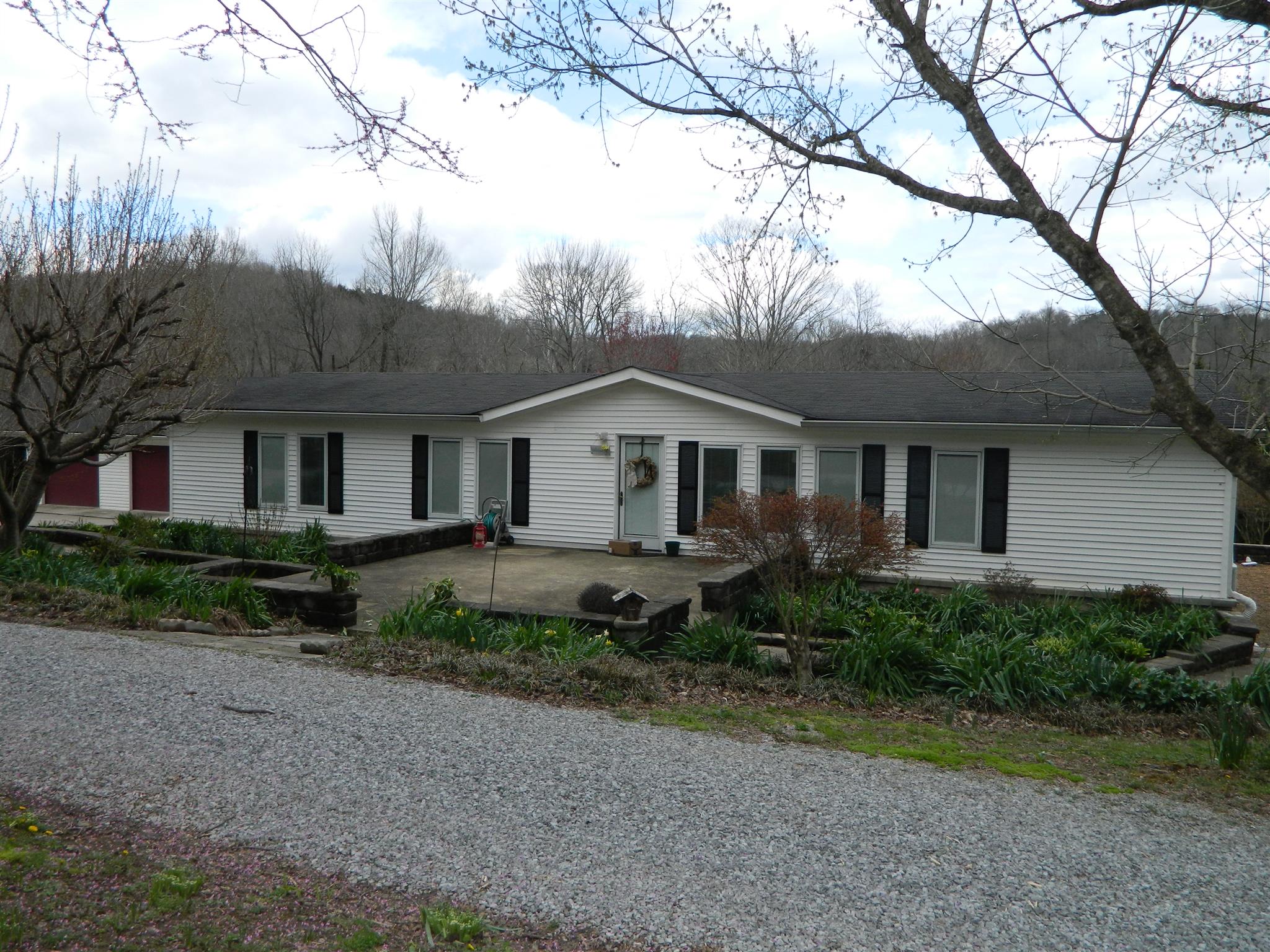 491 Pee Dee Branch Road Cottontown, TN 37048 - Photo 1 of 30 a front view of a house with garden