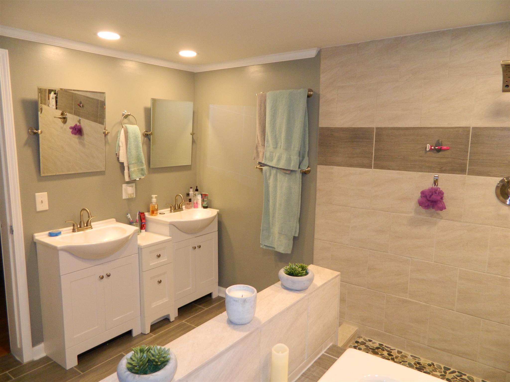491 Pee Dee Branch Road Cottontown, TN 37048 - Photo 19 of 30 a bathroom with a sink mirror and shower