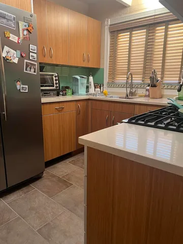 a kitchen with stainless steel appliances a sink a counter space and a window