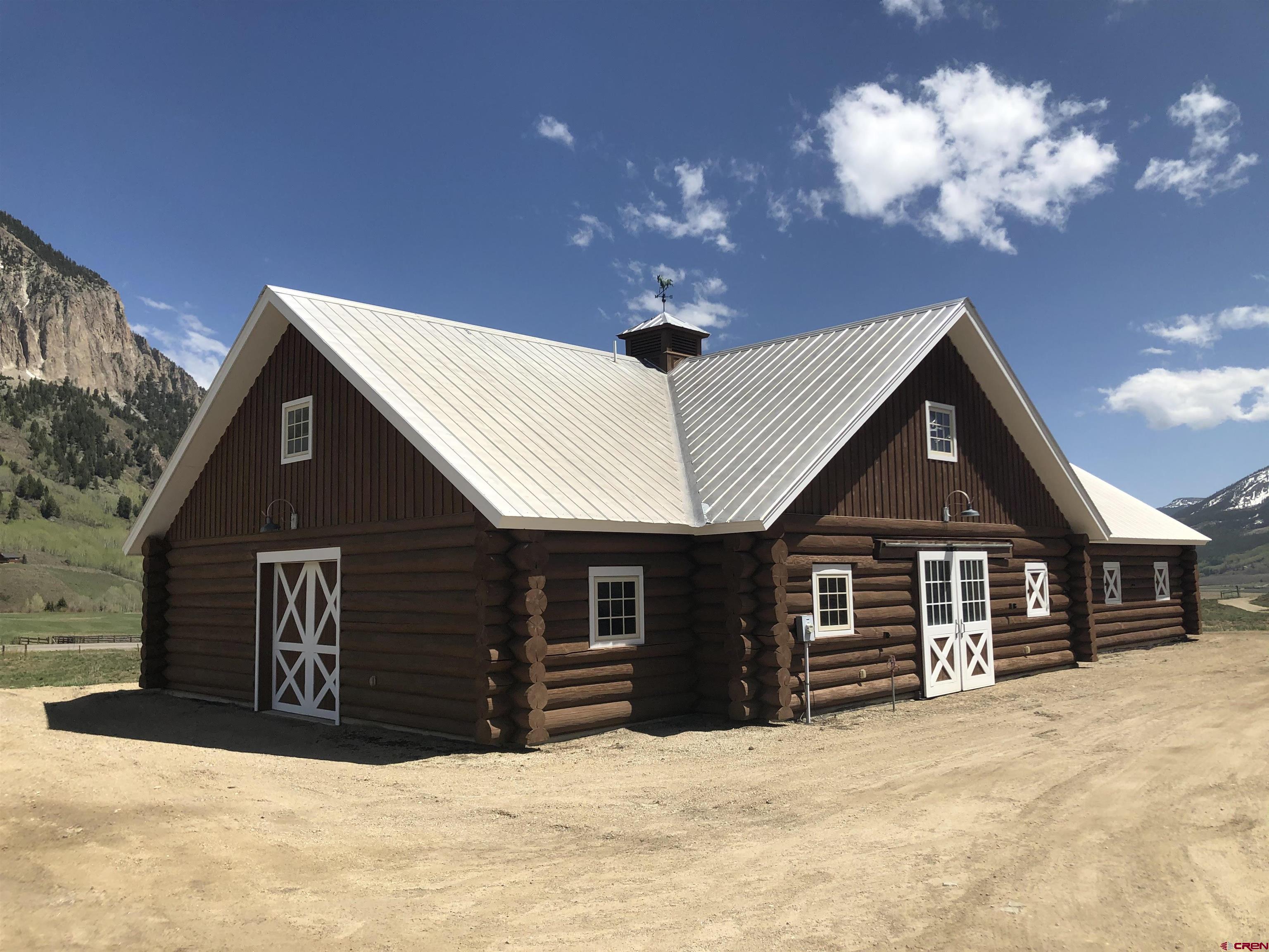 375 Saddle Ridge Ranch Road Crested Butte, CO 81224 - Photo 11 of 12 a front view of a house with a yard covered in snow