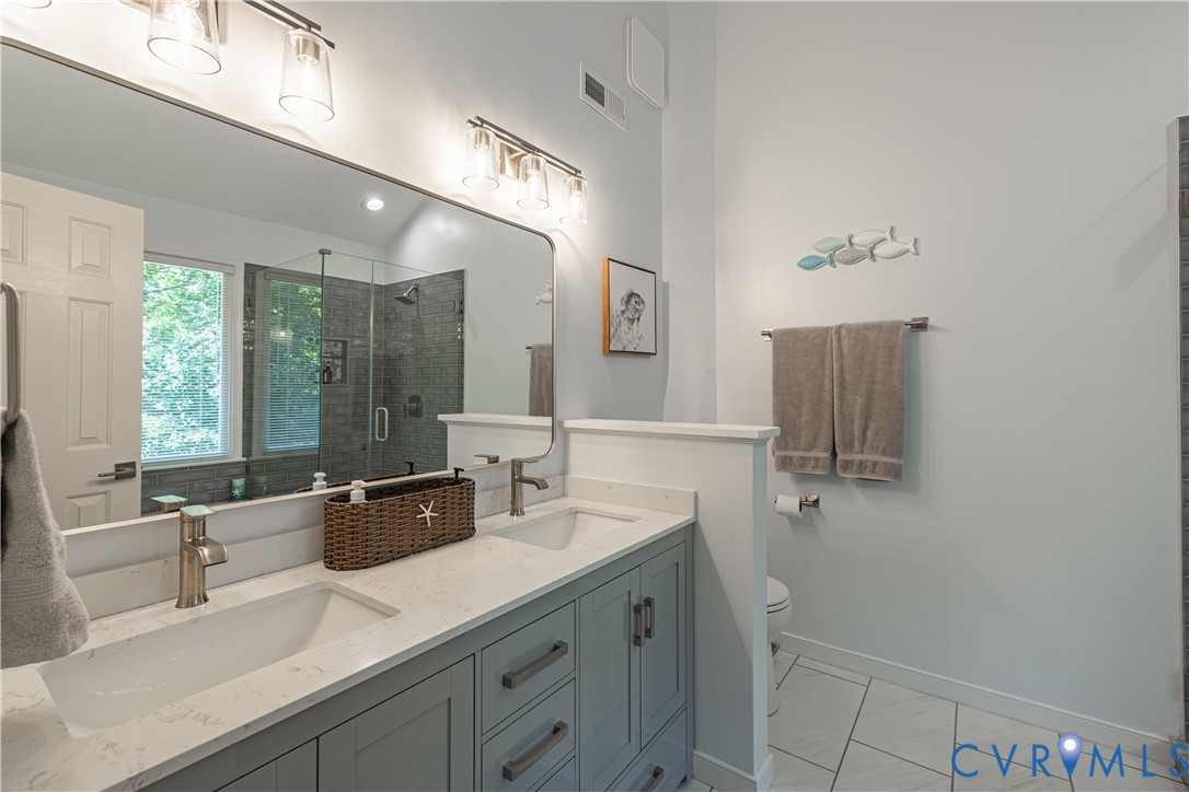 4501 Foxwood Road Chester, VA 23831 - Photo 22 of 42 Double vanity with light gray cabinetry and white