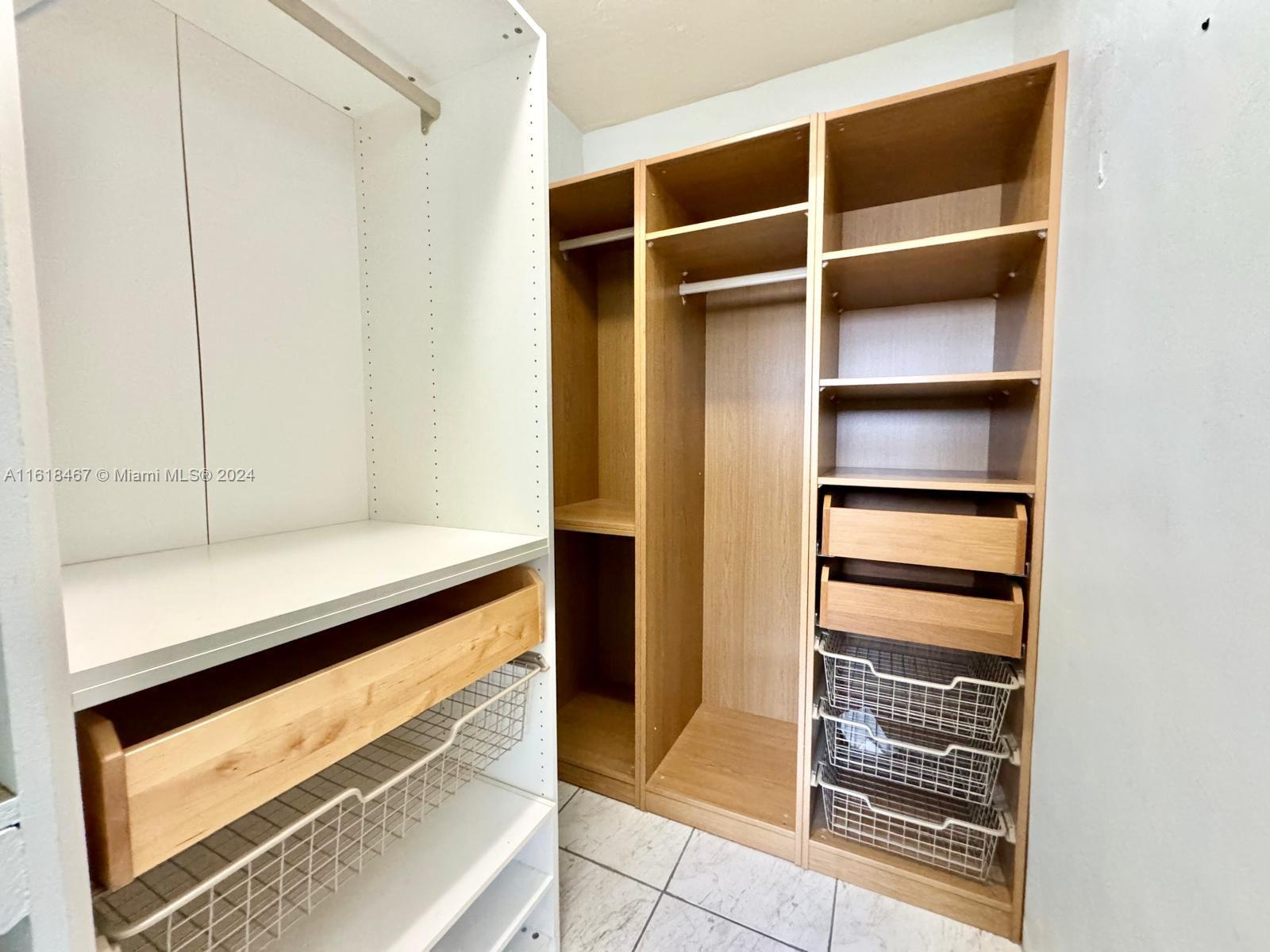 200 76th Street, Unit 52 Miami Beach, FL 33141 - Photo 14 of 16 a view of walk in closet with empty racks
