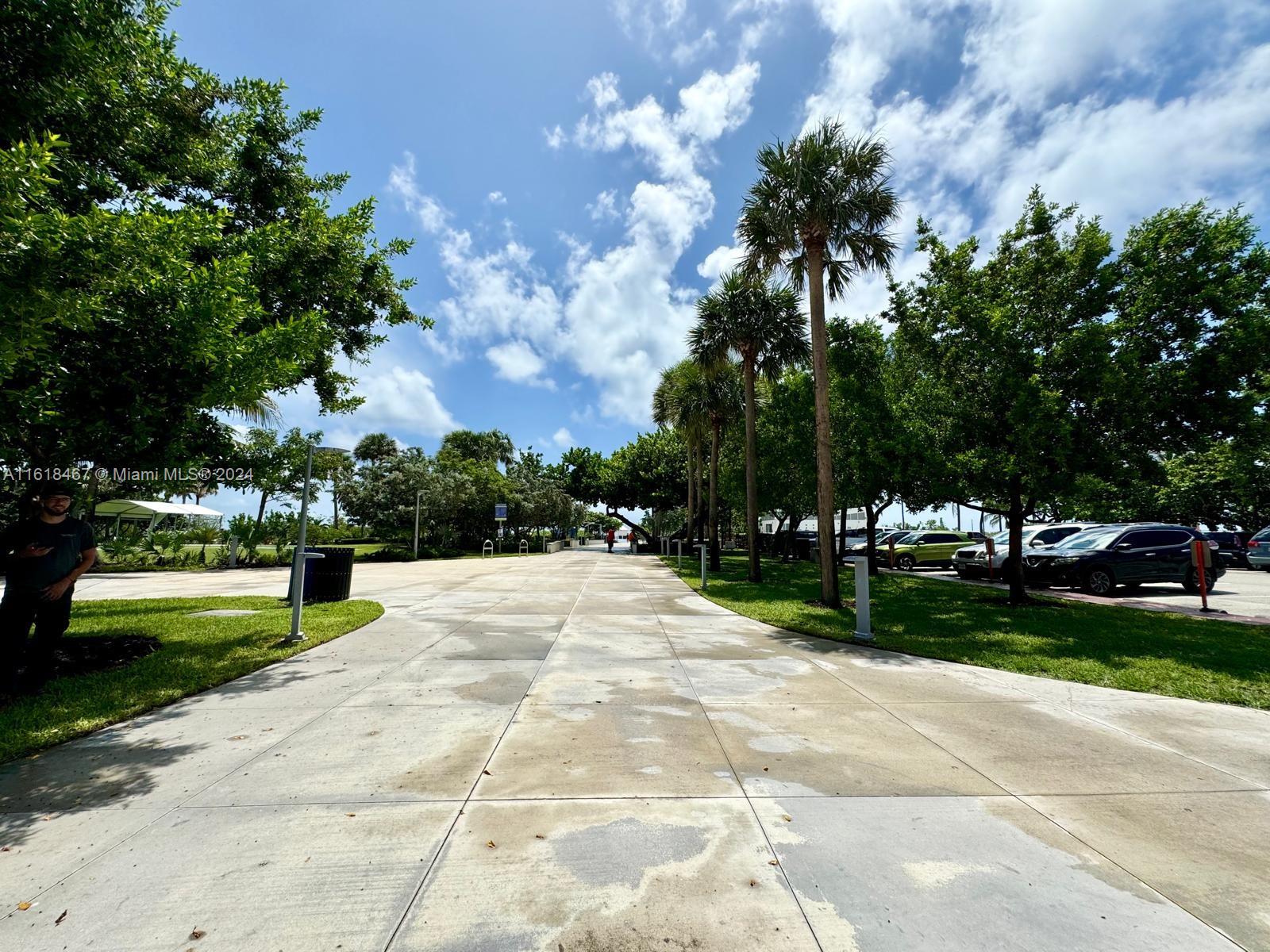 200 76th Street, Unit 52 Miami Beach, FL 33141 - Photo 16 of 16 a park view with a fountain plants and large trees