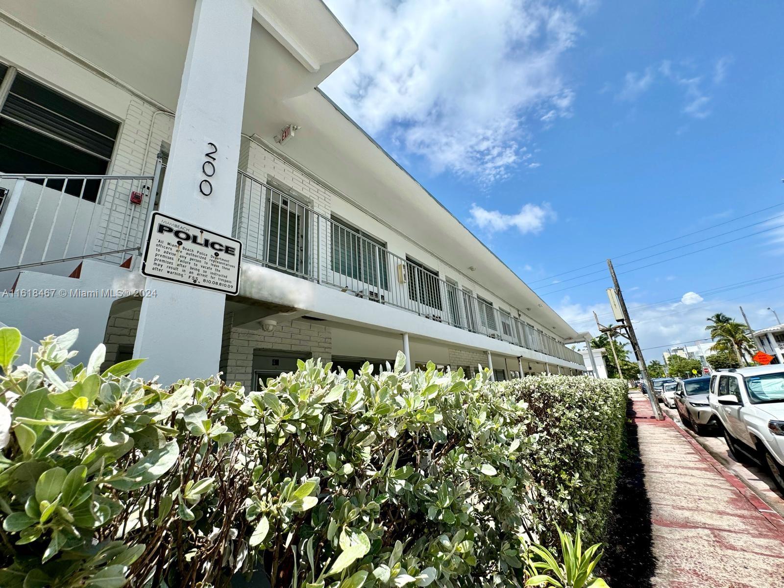 200 76th Street, Unit 52 Miami Beach, FL 33141 - Photo 4 of 16 a view of a large building with a flower garden