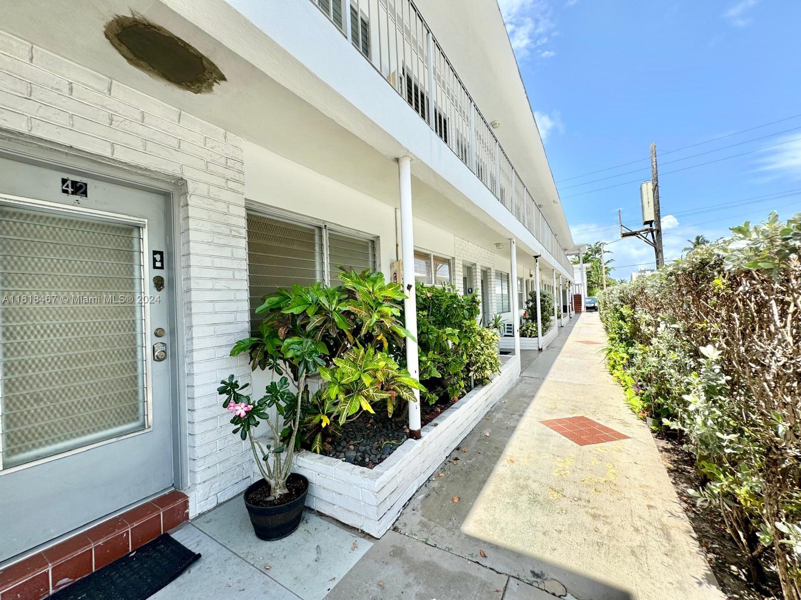 200 76th Street, Unit 52 Miami Beach, FL 33141 - Photo 6 of 16 a view of a pathway with flower pots