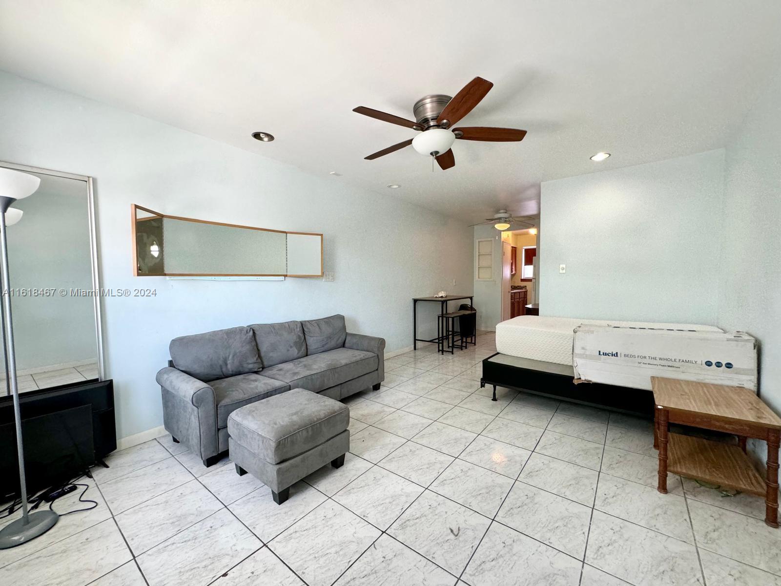 200 76th Street, Unit 52 Miami Beach, FL 33141 - Photo 10 of 16 a living room with furniture and a ceiling fan
