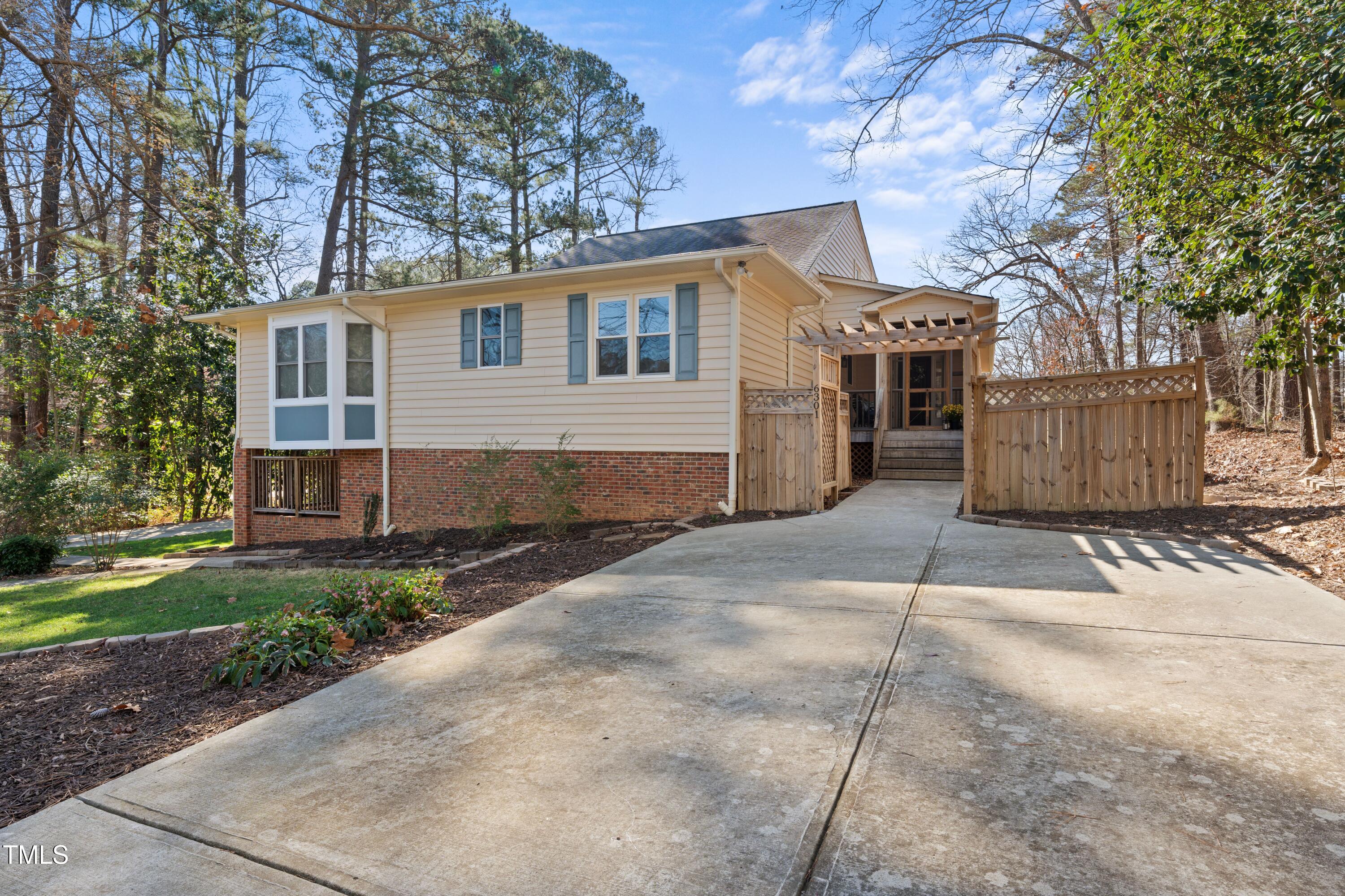 6301 King Lawrence Road Raleigh, NC 27607 - Photo 7 of 79 a front view of a house with a garden and trees