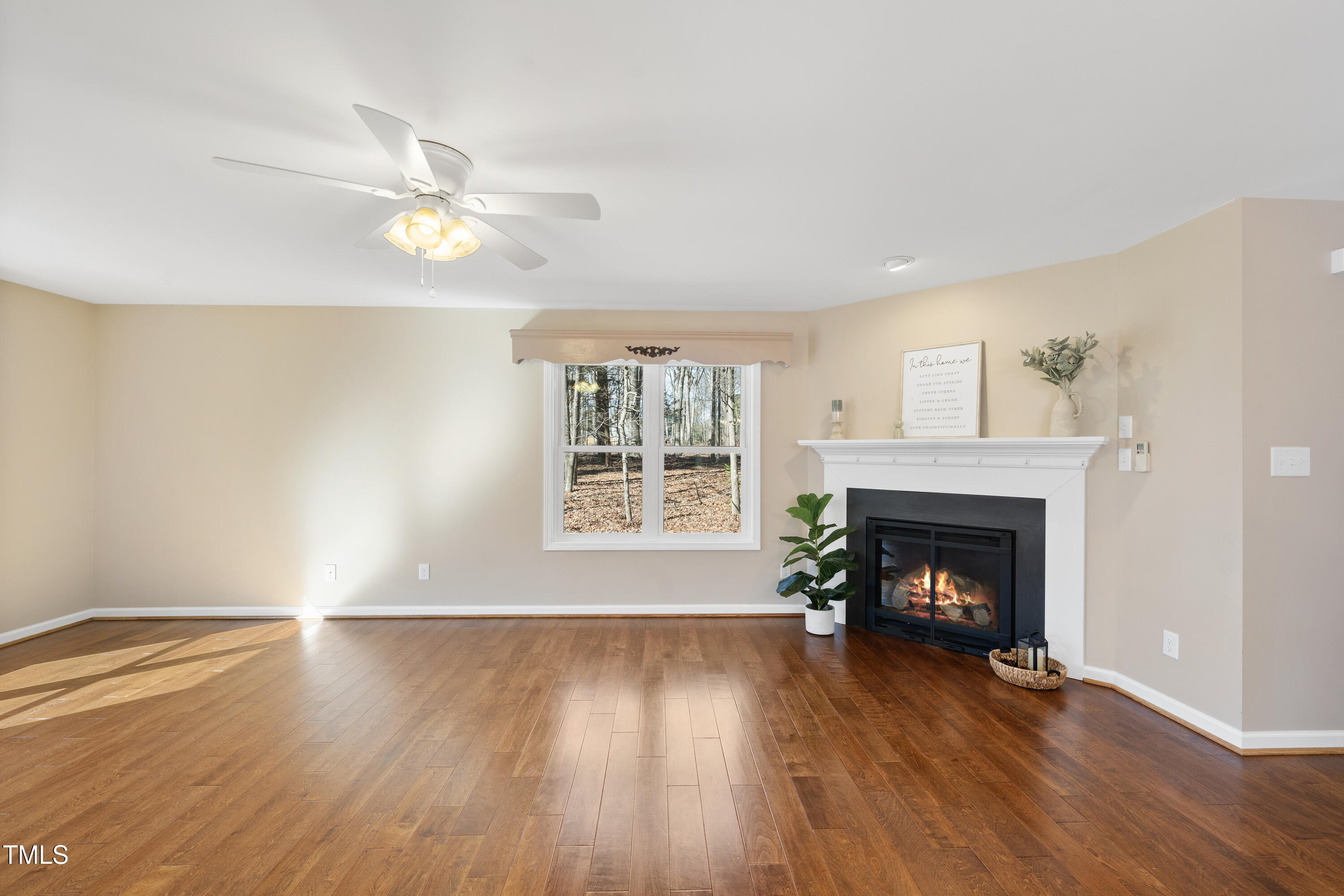 6301 King Lawrence Road Raleigh, NC 27607 - Photo 12 of 79 a view of an empty room with wooden floor fireplace and a window