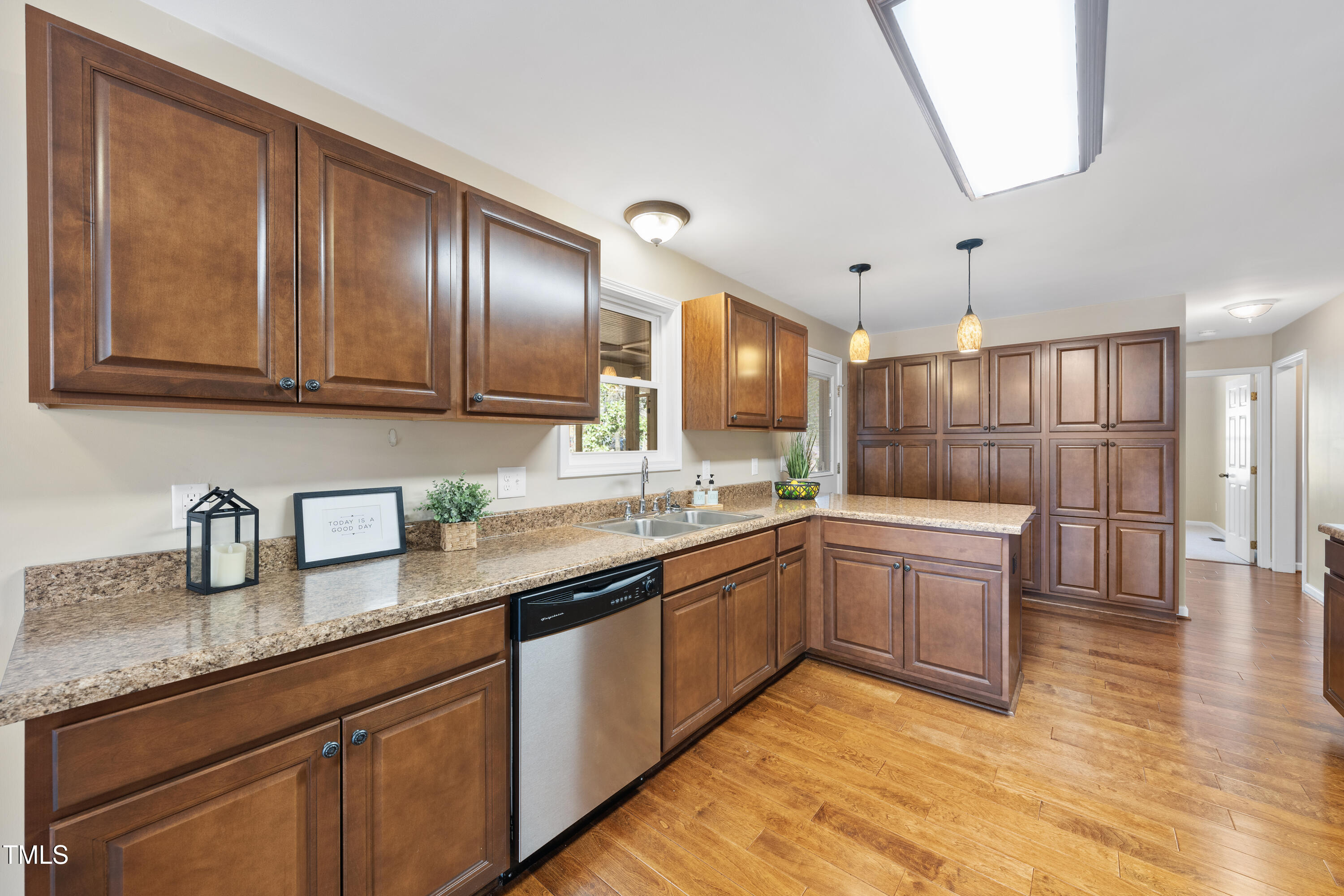 6301 King Lawrence Road Raleigh, NC 27607 - Photo 17 of 79 a large kitchen with granite countertop a sink and dishwasher cabinets with wooden floor