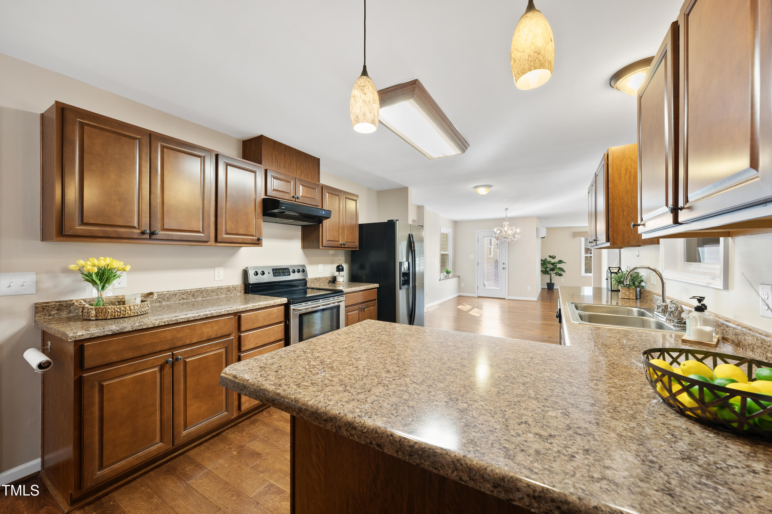 6301 King Lawrence Road Raleigh, NC 27607 - Photo 20 of 79 a kitchen with stainless steel appliances granite countertop a sink dishwasher stove and refrigerator with wooden cabinets