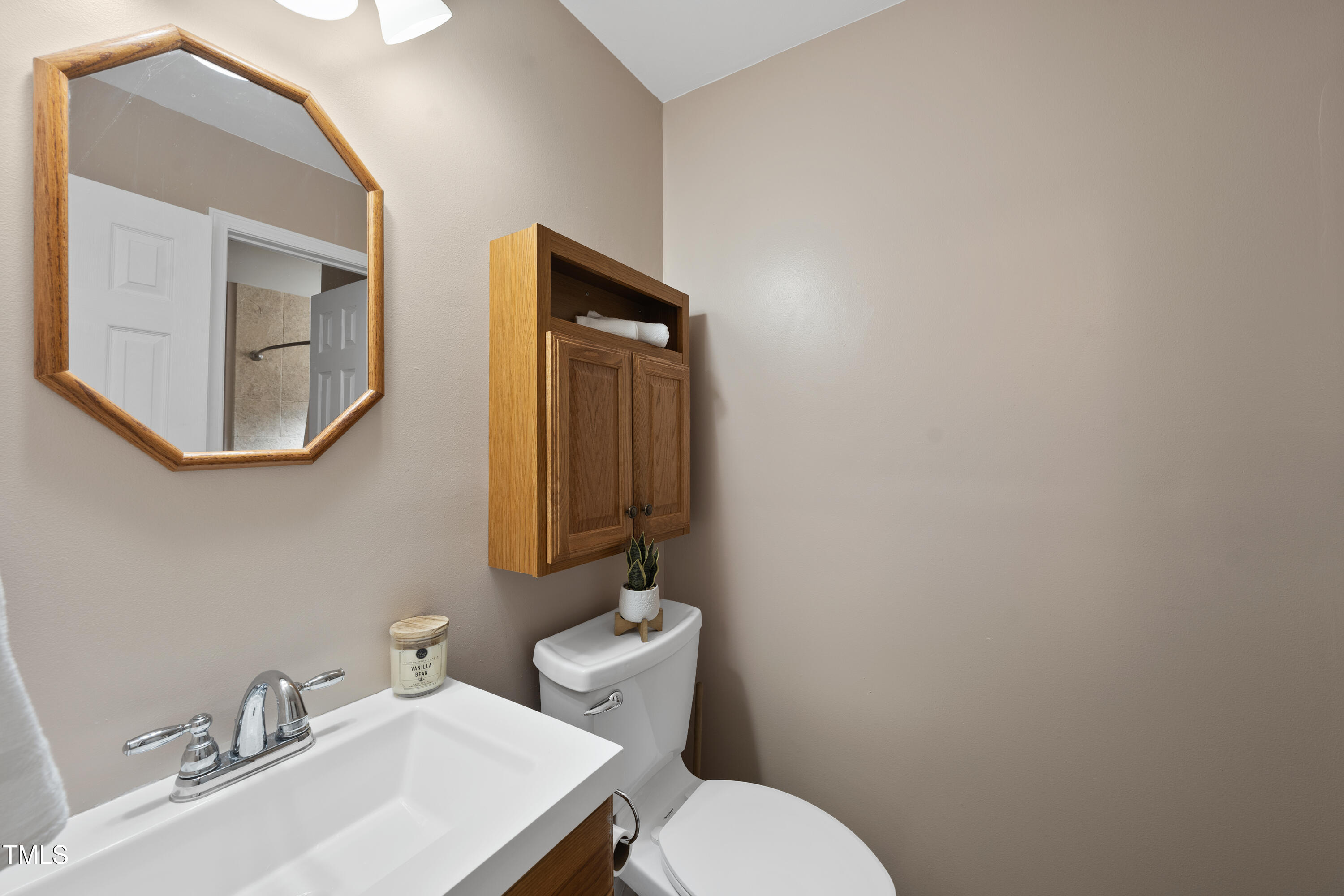 6301 King Lawrence Road Raleigh, NC 27607 - Photo 51 of 79 a bathroom with a toilet sink and mirror