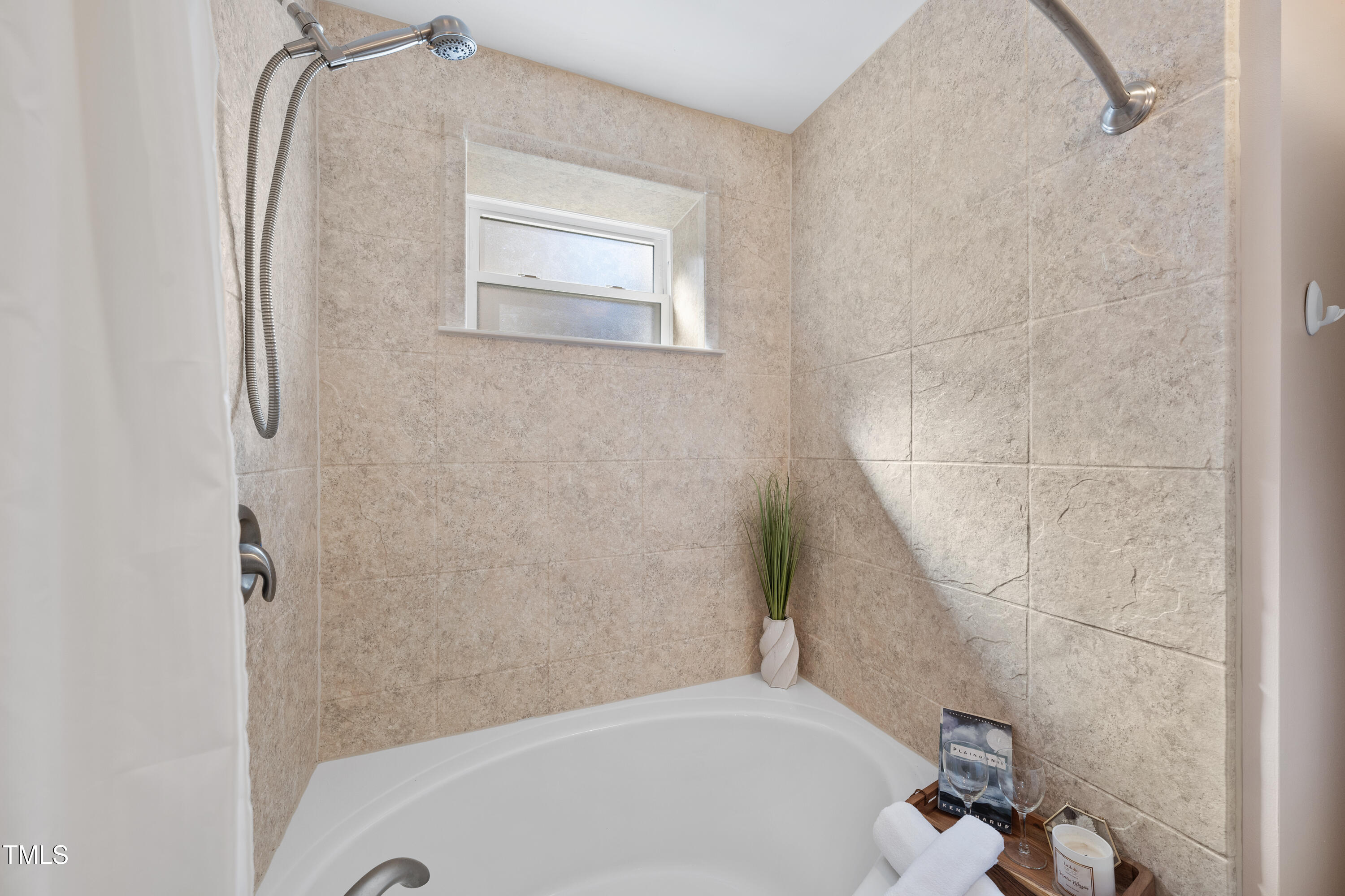 6301 King Lawrence Road Raleigh, NC 27607 - Photo 53 of 79 a bathroom with a tub and a shower