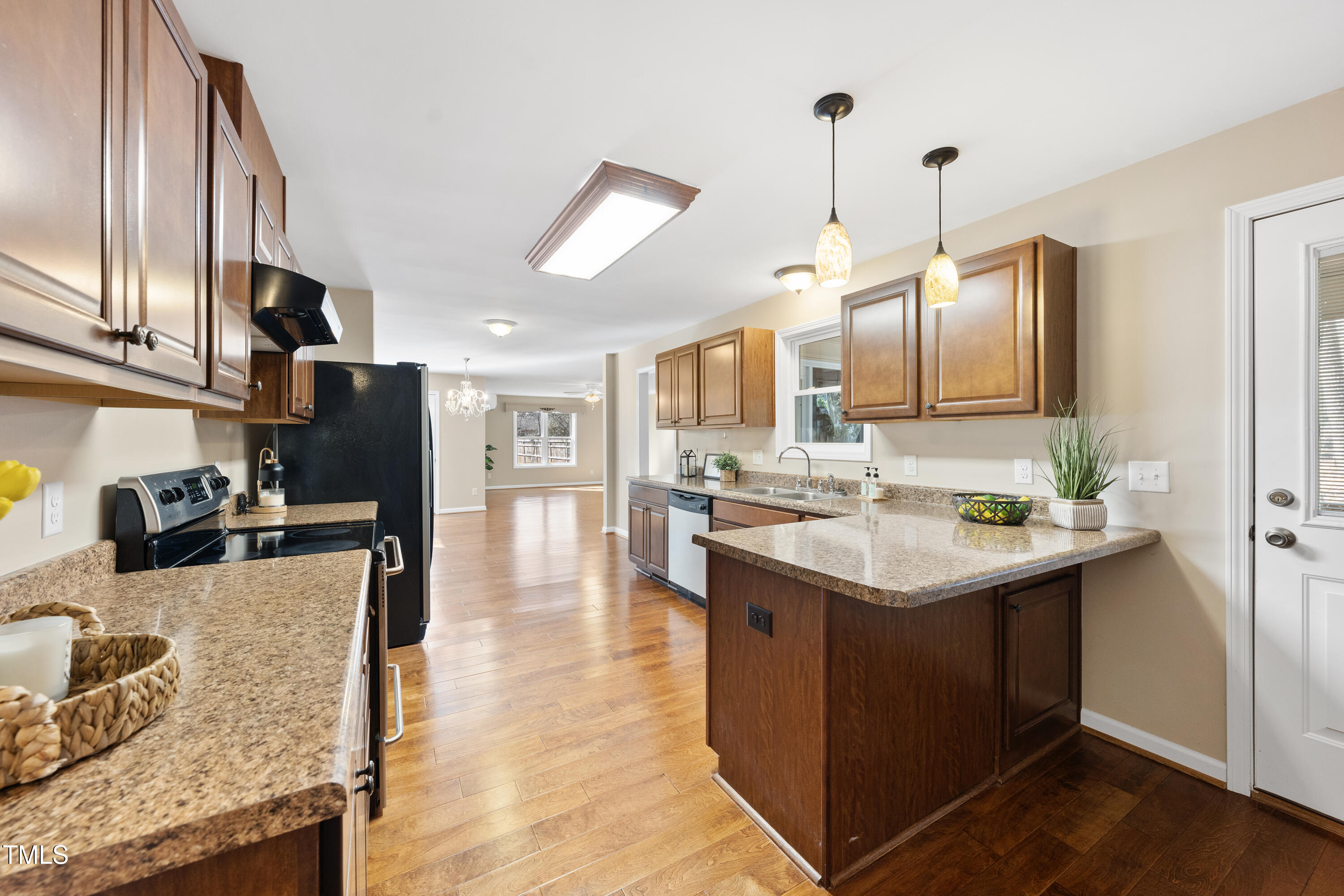 6301 King Lawrence Road Raleigh, NC 27607 - Photo 5 of 79 a kitchen with stainless steel appliances granite countertop a sink a stove and a wooden floors