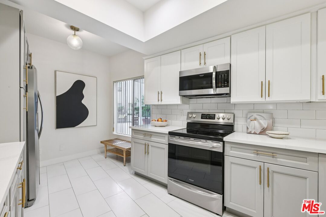 4242 Stansbury Avenue, Unit 104 Sherman Oaks, CA 91423 - Photo 15 of 38 a kitchen with a sink and a stove top oven
