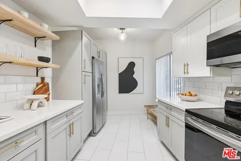 a kitchen with a sink stainless steel appliances and cabinets