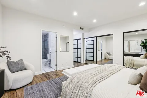 a bedroom with a large bed and a couch