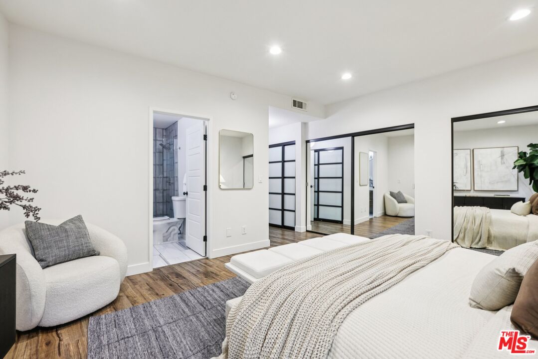 4242 Stansbury Avenue, Unit 104 Sherman Oaks, CA 91423 - Photo 24 of 38 a bedroom with a large bed and a couch