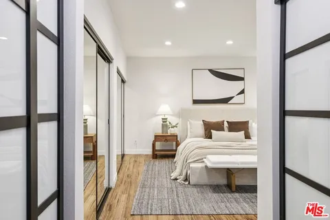 a bedroom with furniture and a mirror