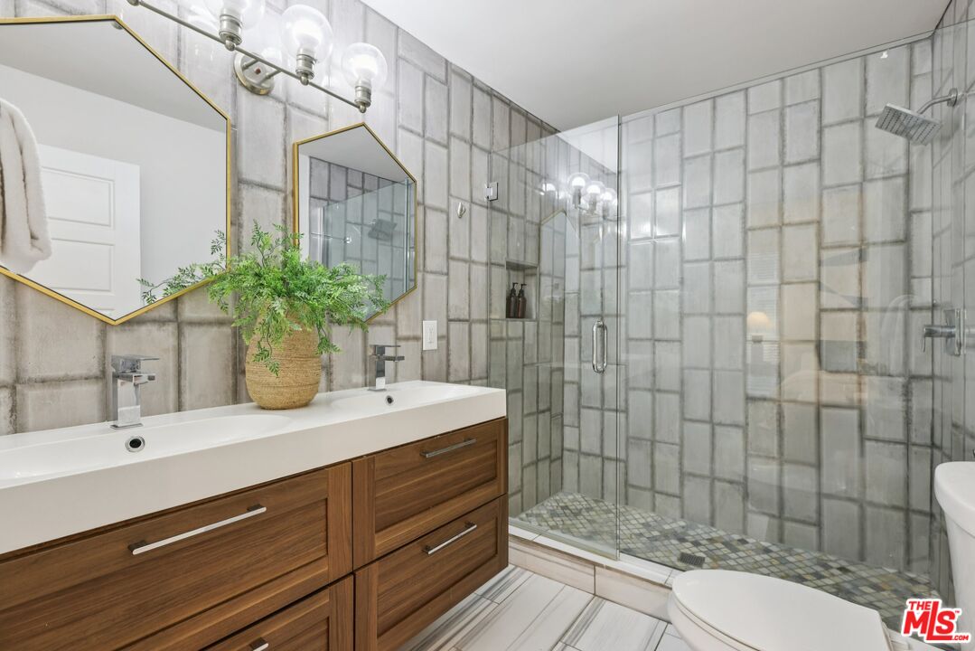 4242 Stansbury Avenue, Unit 104 Sherman Oaks, CA 91423 - Photo 26 of 38 a bathroom with a sink and a mirror