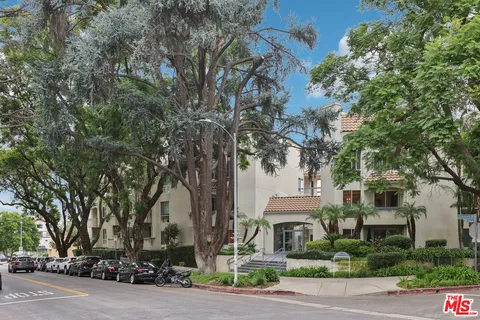 a front view of a building with tree s