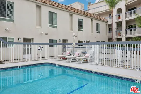 a view of a house with wooden deck and furniture