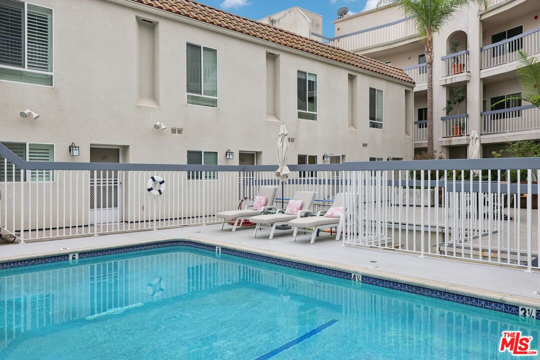 4242 Stansbury Avenue, Unit 104 Sherman Oaks, CA 91423 - Photo 33 of 38 a view of a house with wooden deck and furniture