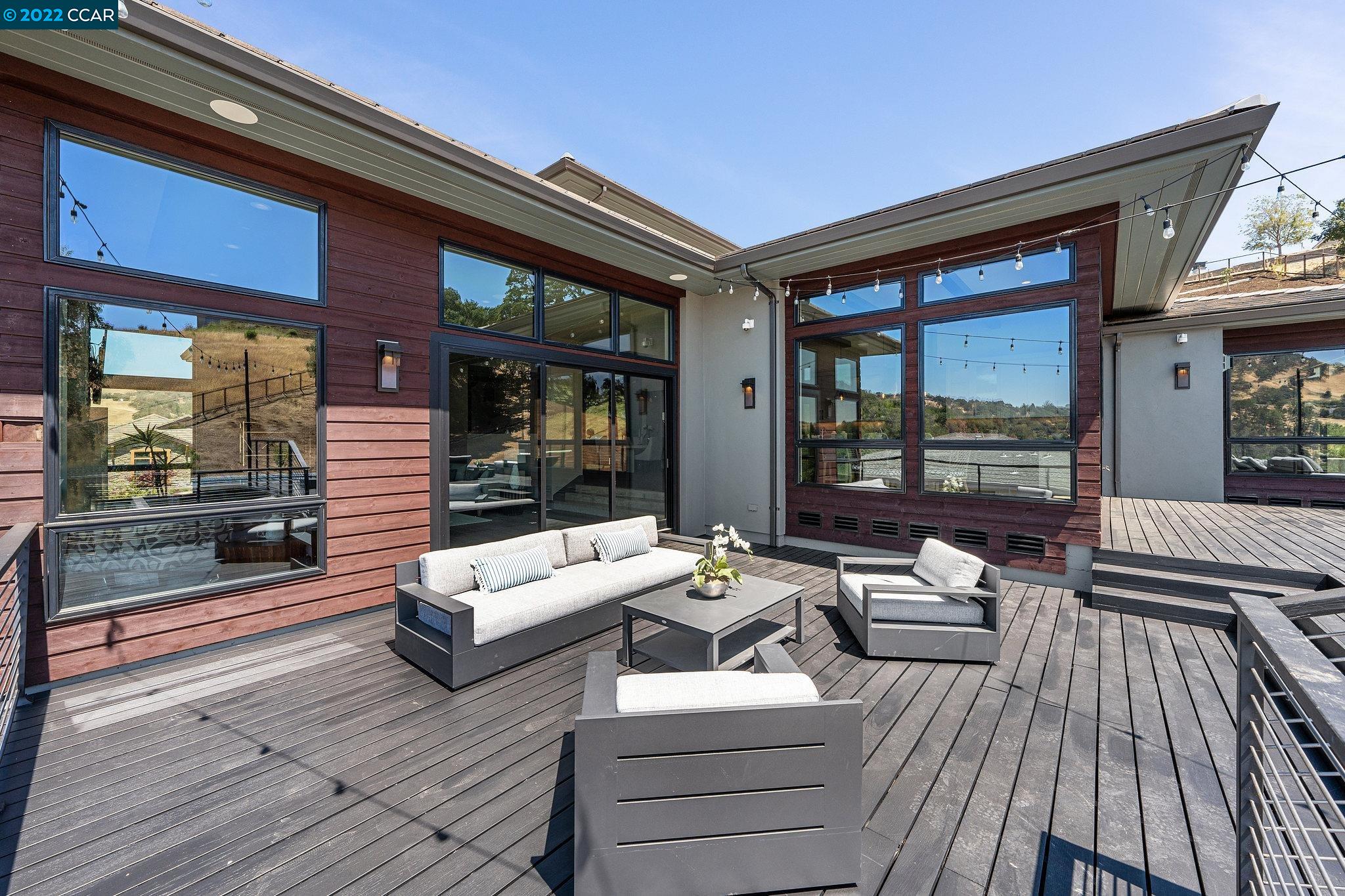 155 Arbor View Lane Lafayette, CA 94549 - Photo 6 of 32 a view of a patio with couches and dining table with wooden floor