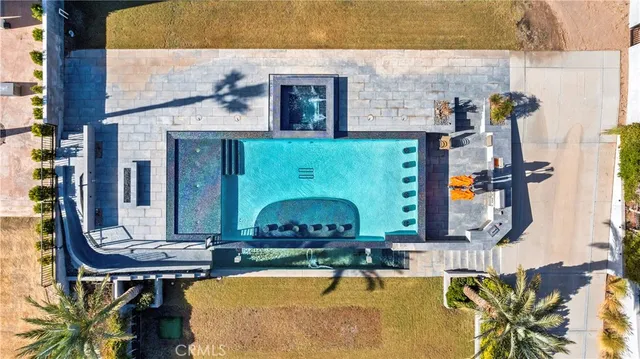 an aerial view of a house with outdoor seating