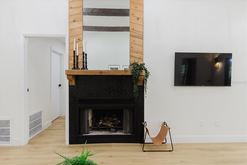 8304 Revels Road Riverview, FL 33569 - Photo 93 of 99 a living room with a fireplace and a flat screen tv