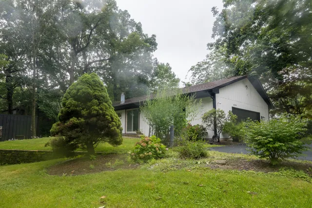 a view of a house with a yard and plants