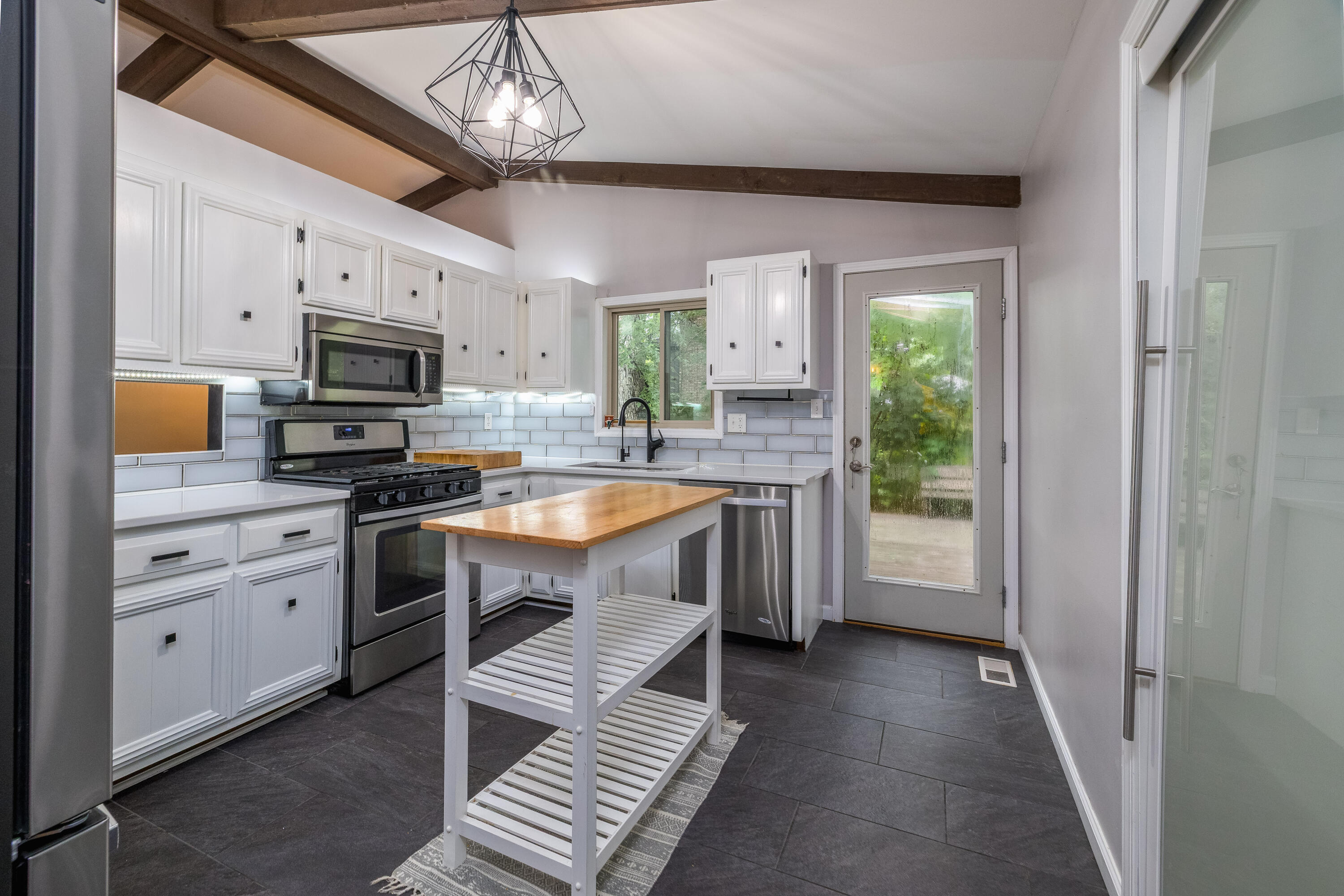 4270 Park Place Crown Point, IN 46307 - Photo 20 of 36 a kitchen with granite countertop a sink appliances cabinets and a counter top space