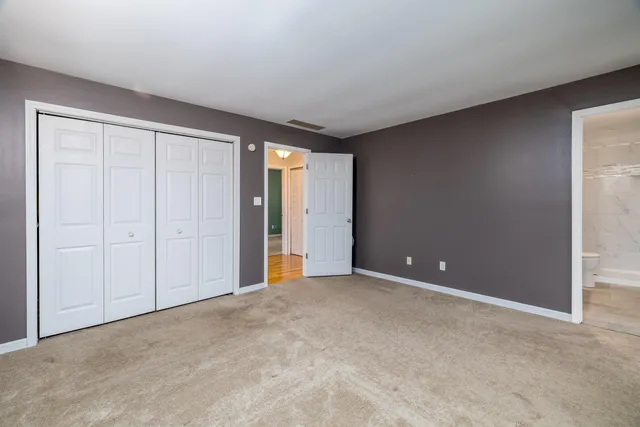 an empty room with closet area