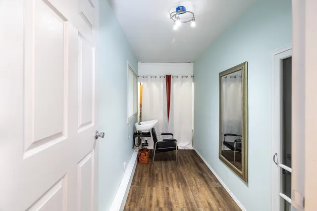 a view of a room with wooden floor and staircase