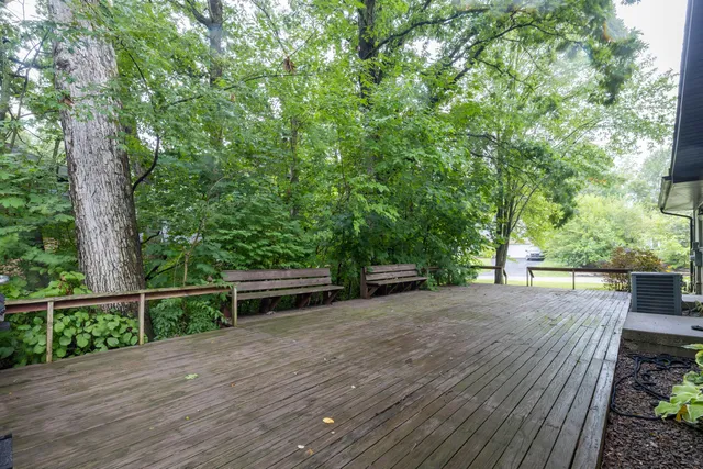 a view of a backyard with wooden floor and fence
