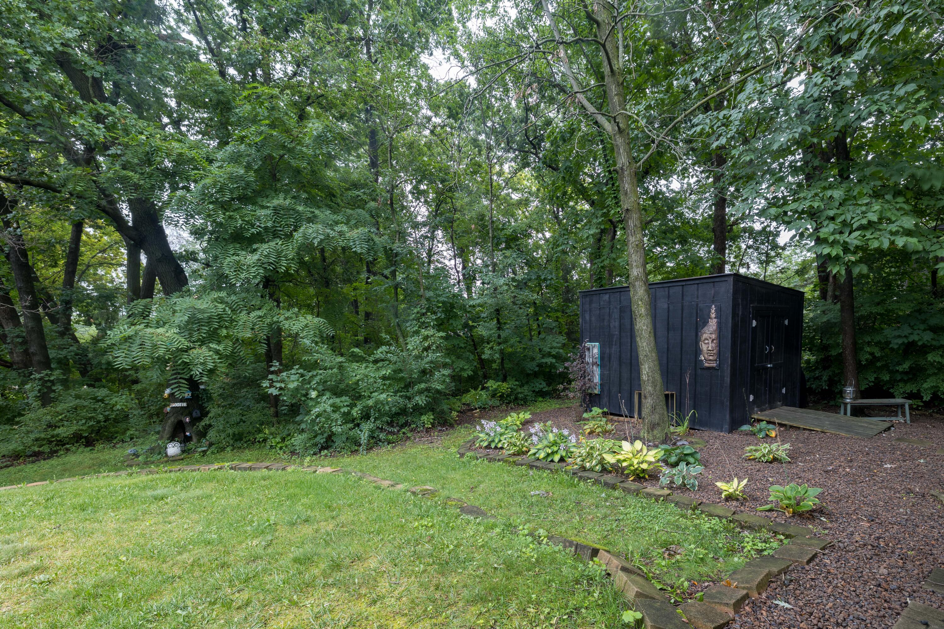 4270 Park Place Crown Point, IN 46307 - Photo 8 of 36 a view of a backyard with potted plants and large trees
