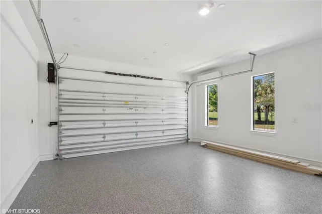 a view of a hallway with wooden floor and a living room