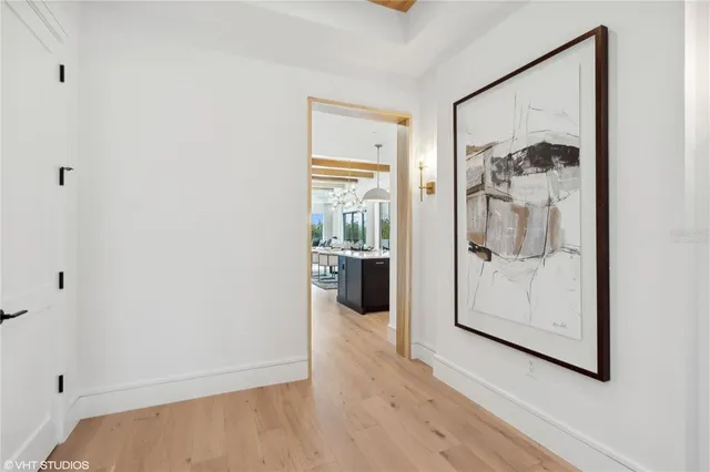 a bedroom with a large bed and a chandelier