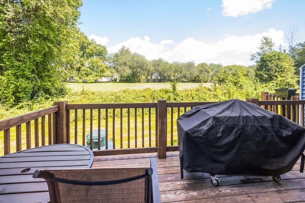 59 Seabury, Unit 59 Hampton, NH 03842 - Photo 2 of 25 a view of a deck with a floor to ceiling window next to a yard