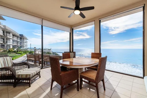 a dining room with furniture and a floor to ceiling window
