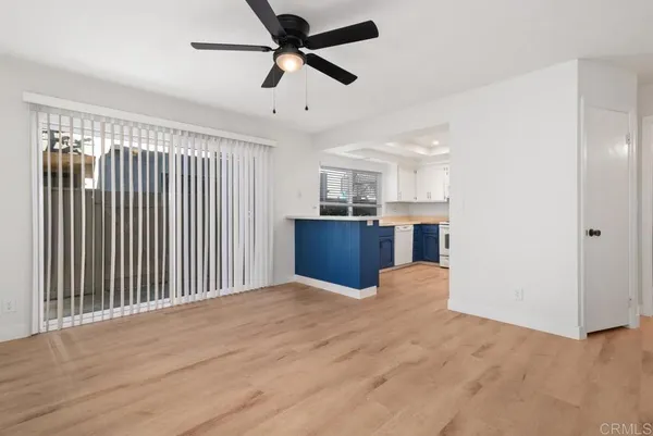 a view of a kitchen with a refrigerator and a ceiling fan