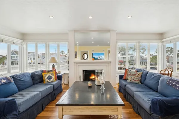 a living room with furniture fireplace and a large window