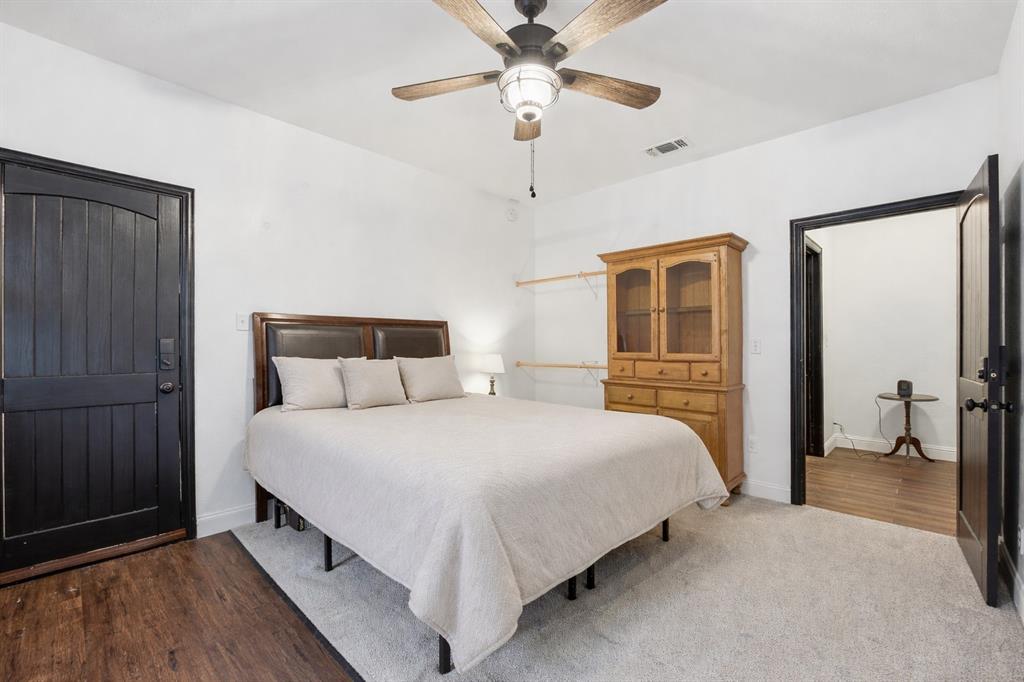 156 Howard Newby Lane Springtown, TX 76082 - Photo 6 of 11 a bedroom with bed and wooden floor