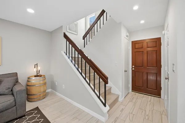 a view of entryway and hall with wooden floor