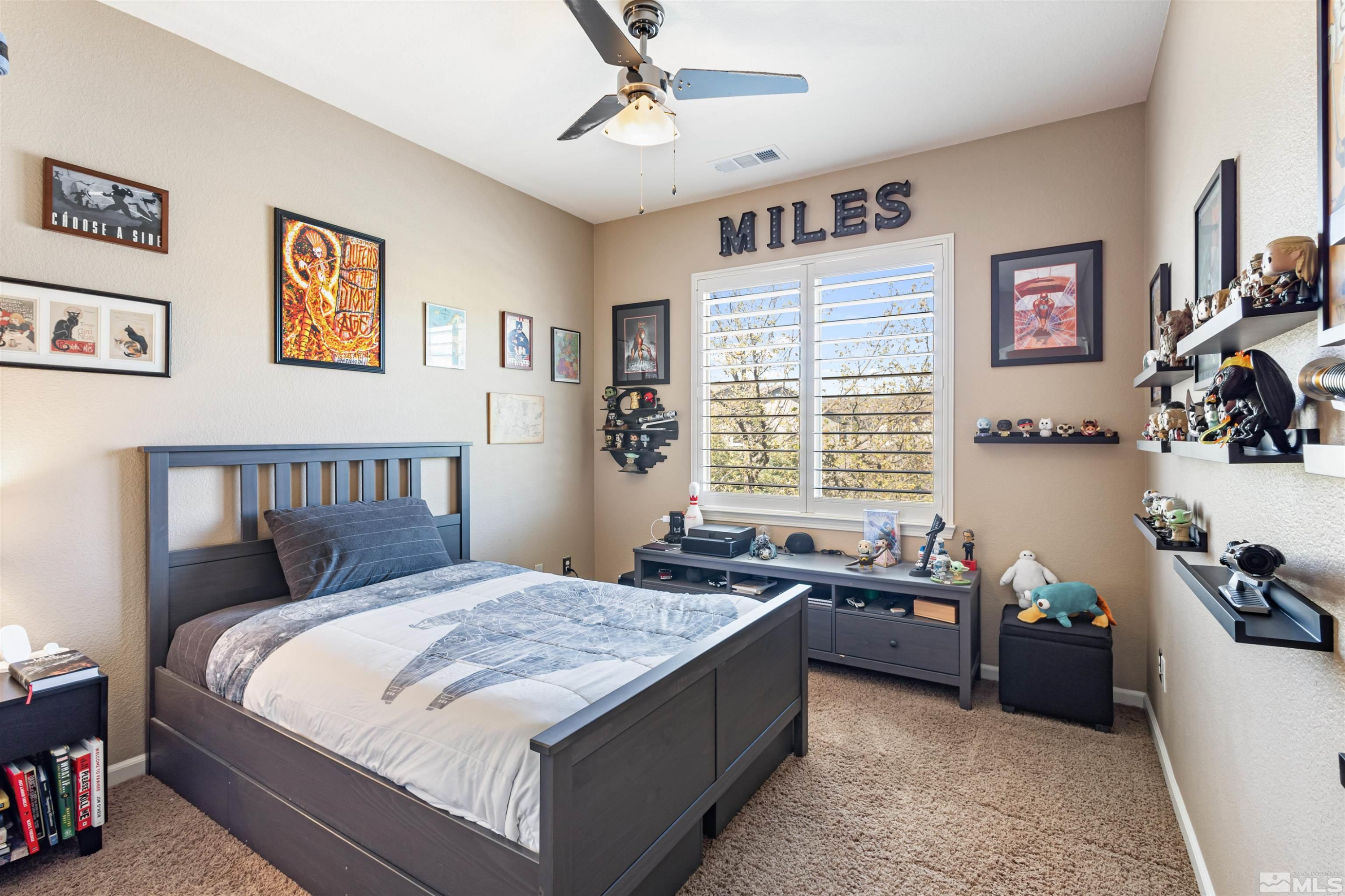 14025 Tagor Road Reno, NV 89521 - Photo 26 of 39 a bed sitting in a bedroom next to a window with a baby crib